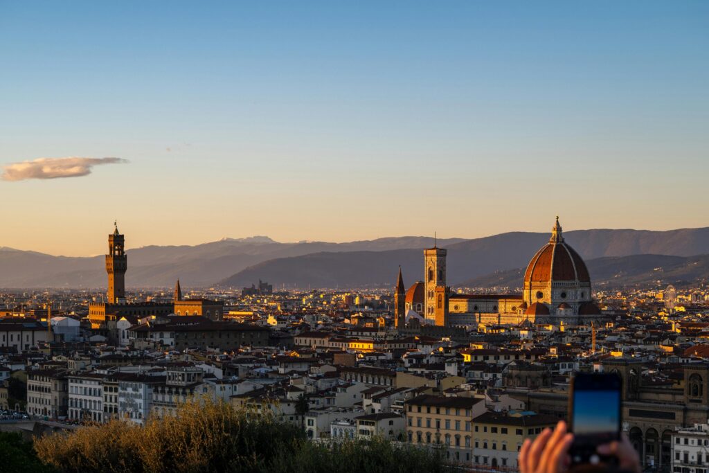 Captivating sunset view of Florence skyline featuring the iconic Cathedral and Palazzo Vecchio.